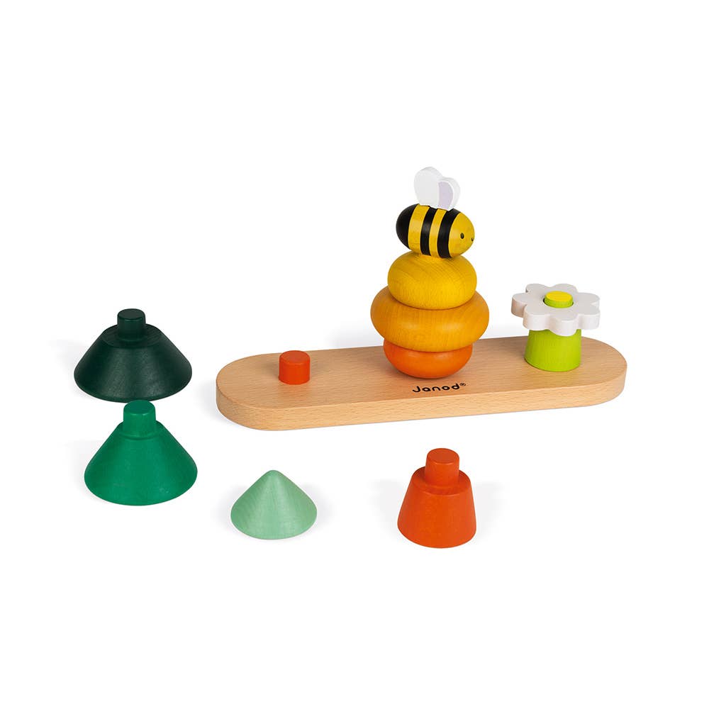 Wooden toy set with trees, a bee, and a flower on a white background