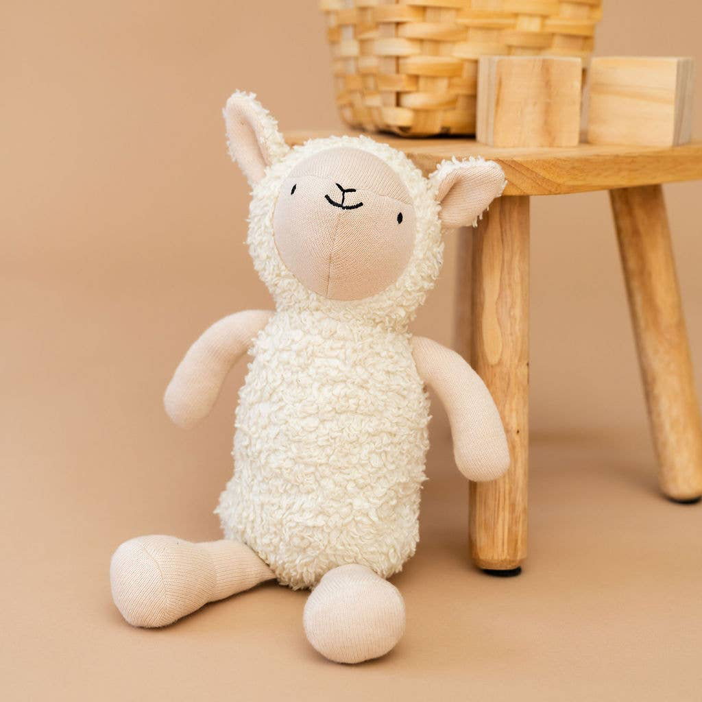 Stuffed toy sheep on a white background