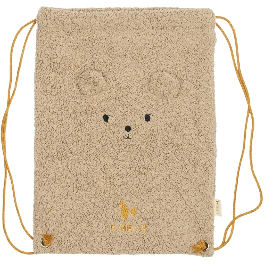 Beige drawstring bag with bear face design on a white background
