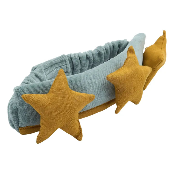 Light blue headband with mustard yellow star-shaped decorations on a white background