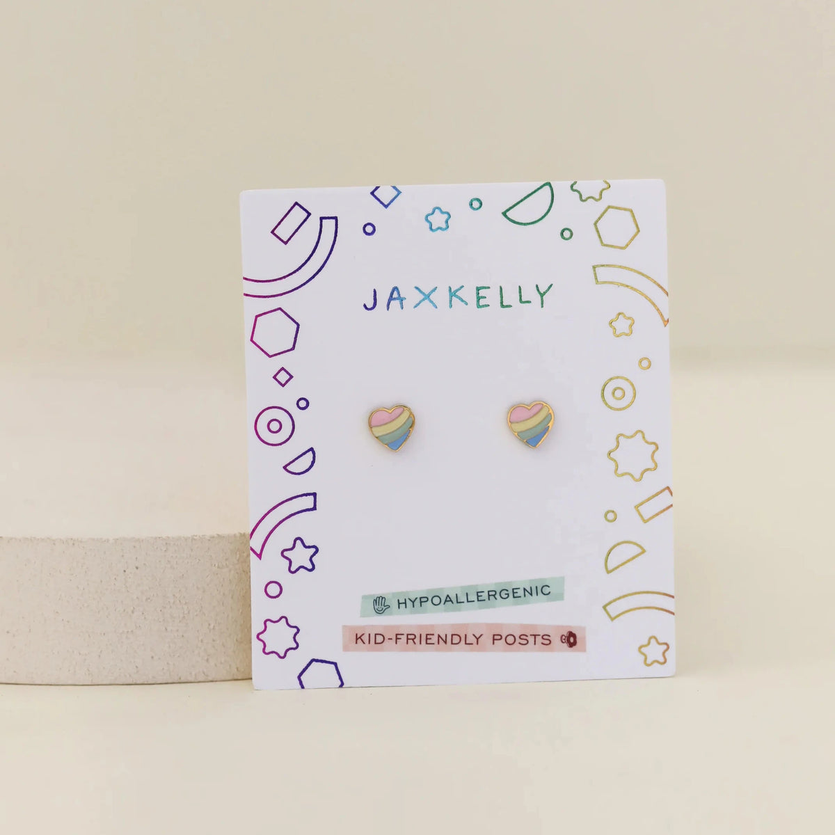 Jaxkelly earrings on a branded card with geometric designs on a beige background