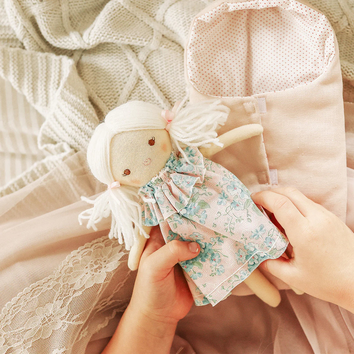 child holding doll