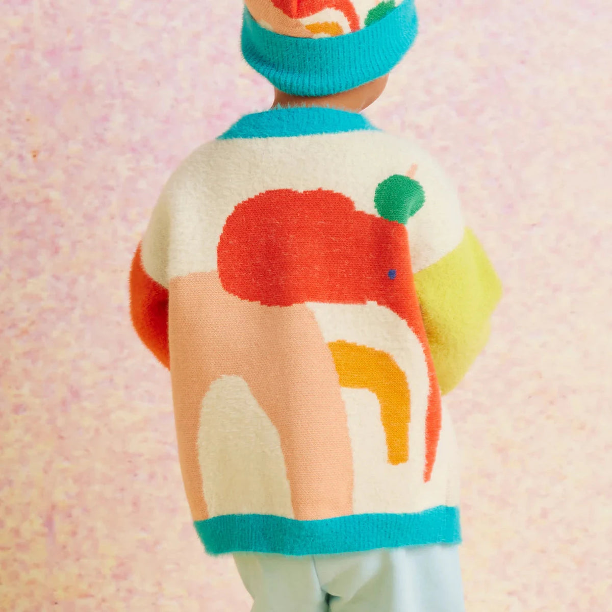 Child wearing elephant cardigan showing the backside