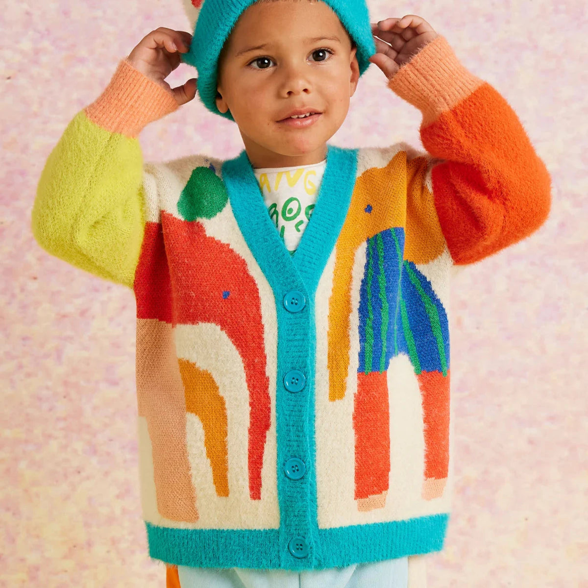 Child wearing elephant print cardigan