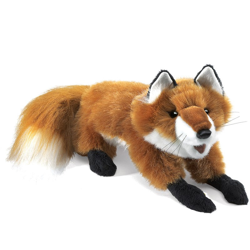 Child holding a plush fox toy against a plain background