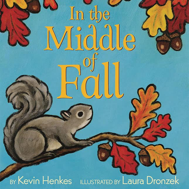 Children's book cover titled "In the Middle of Fall" with a blue background, autumn leaves in red, orange, and yellow, a gray squirrel on a branch, and the text "By Kevin Henkes" and "Illustrated by Laura Dronzek.".