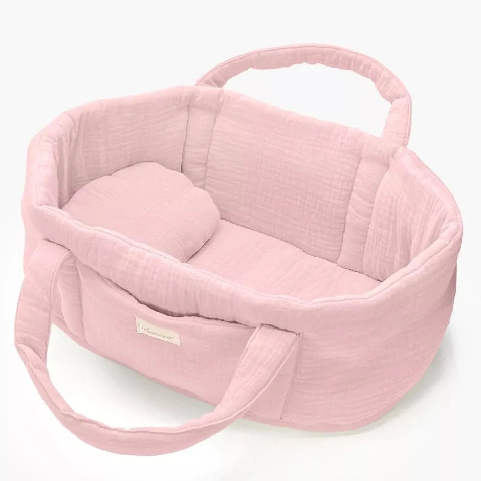 Pink baby doll bed with handle on a white background