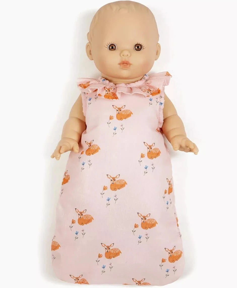 A baby doll wearing a pink sleeveless sleeping bag with an orange deer and small blue flower pattern, shown against a plain white background.