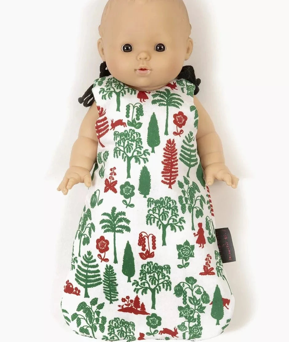 A baby doll wearing a sleeveless white sleep sack with a green and red forest pattern, shown against a plain white background.