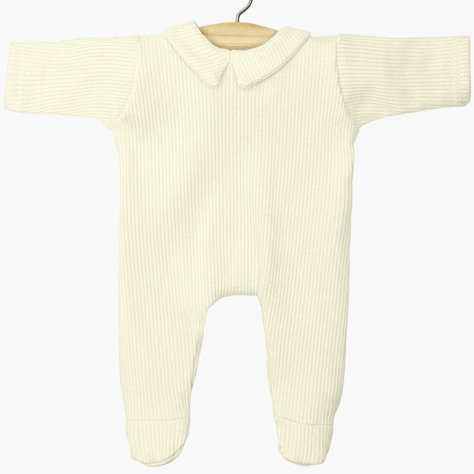 Cream-colored baby doll onesie on a hanger against a white background