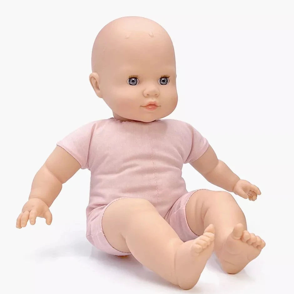 Baby doll wearing a pink outfit on a white background