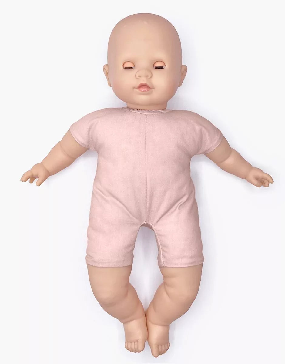 Baby doll wearing a pink onesie on a white background