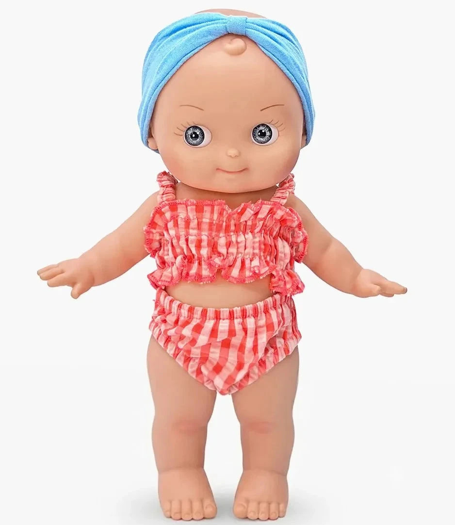 A doll with a blue headwrap wearing a red and white gingham two-piece swimsuit, standing against a plain white background.