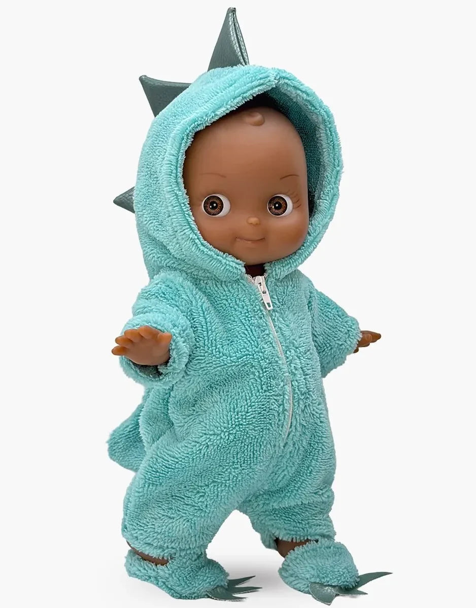 A plush baby doll wearing a light blue-green hooded dinosaur onesie with gray spikes and claw details, shown against a plain light gray background.