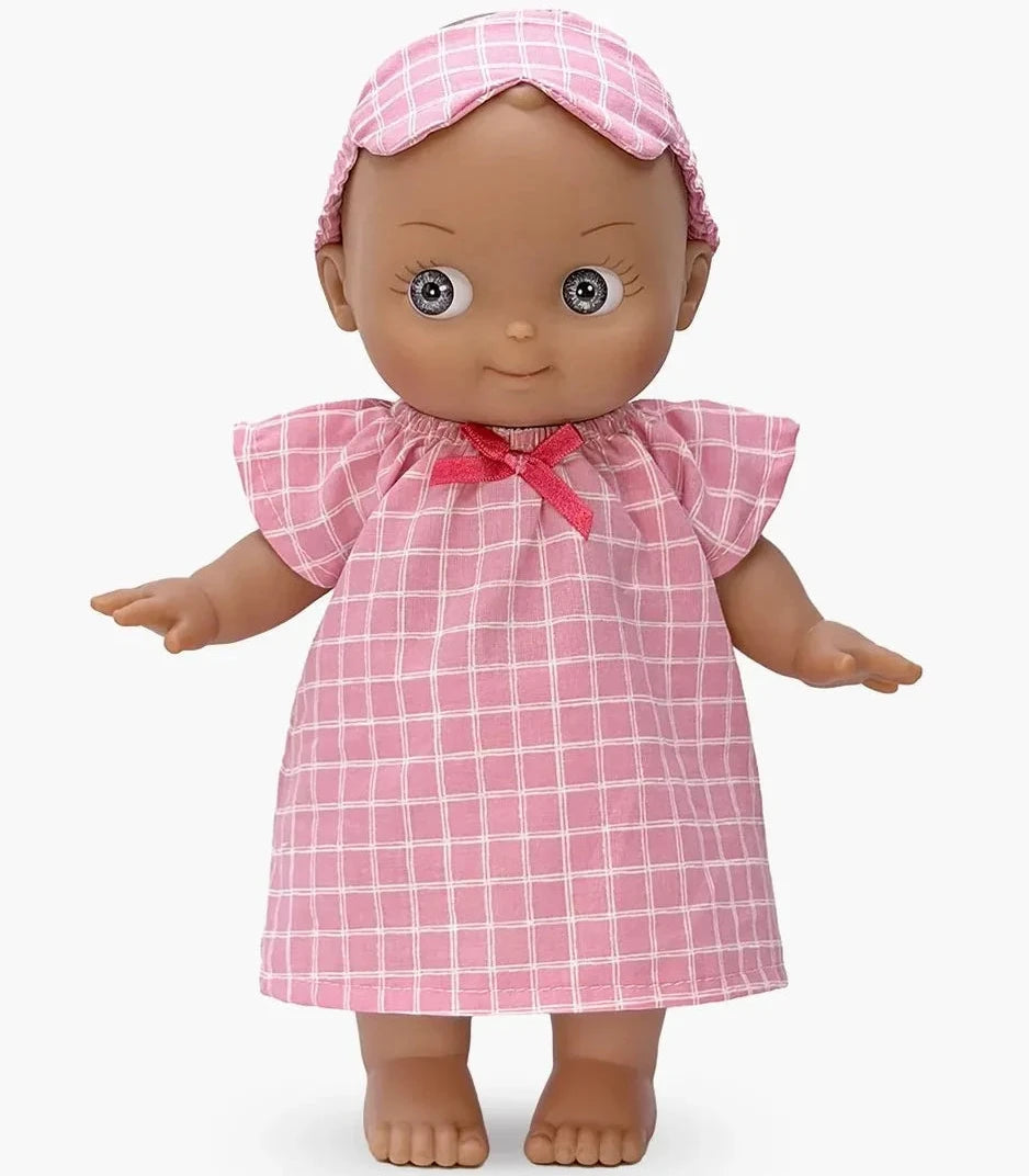 A baby doll wearing a pink and white checkered dress and matching bonnet with a pink bow, set against a plain light gray background.