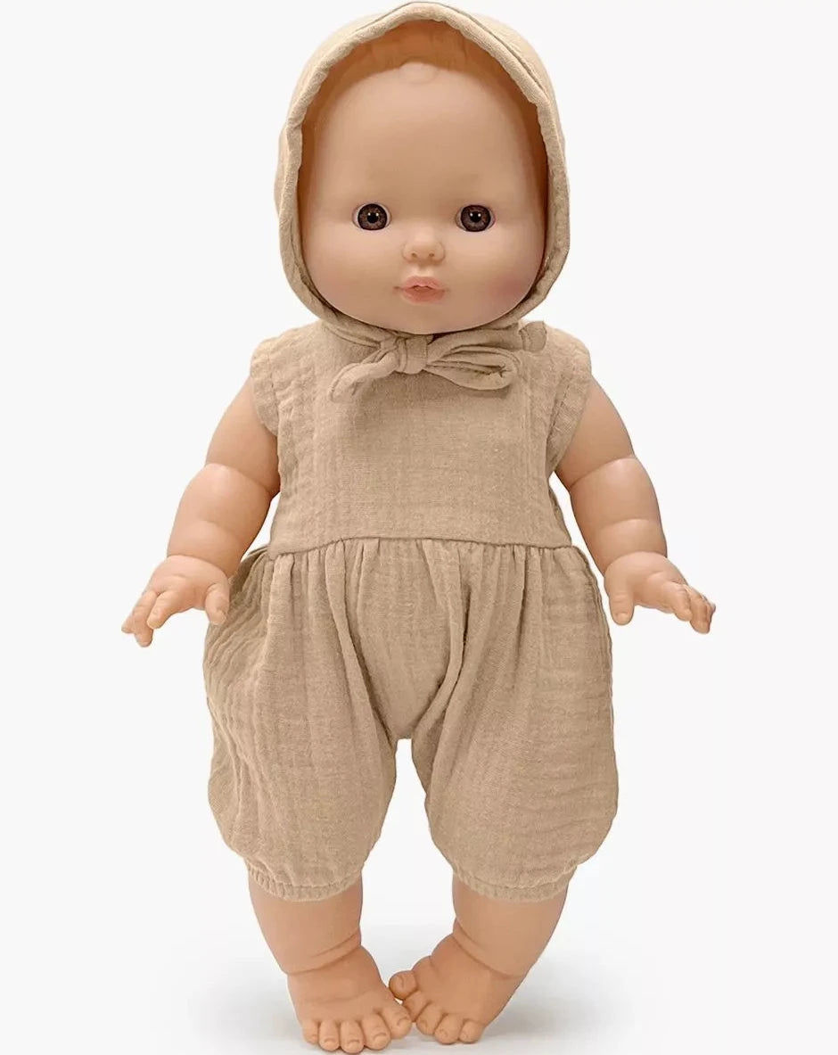 Baby doll wearing a beige outfit with a hood on a white background