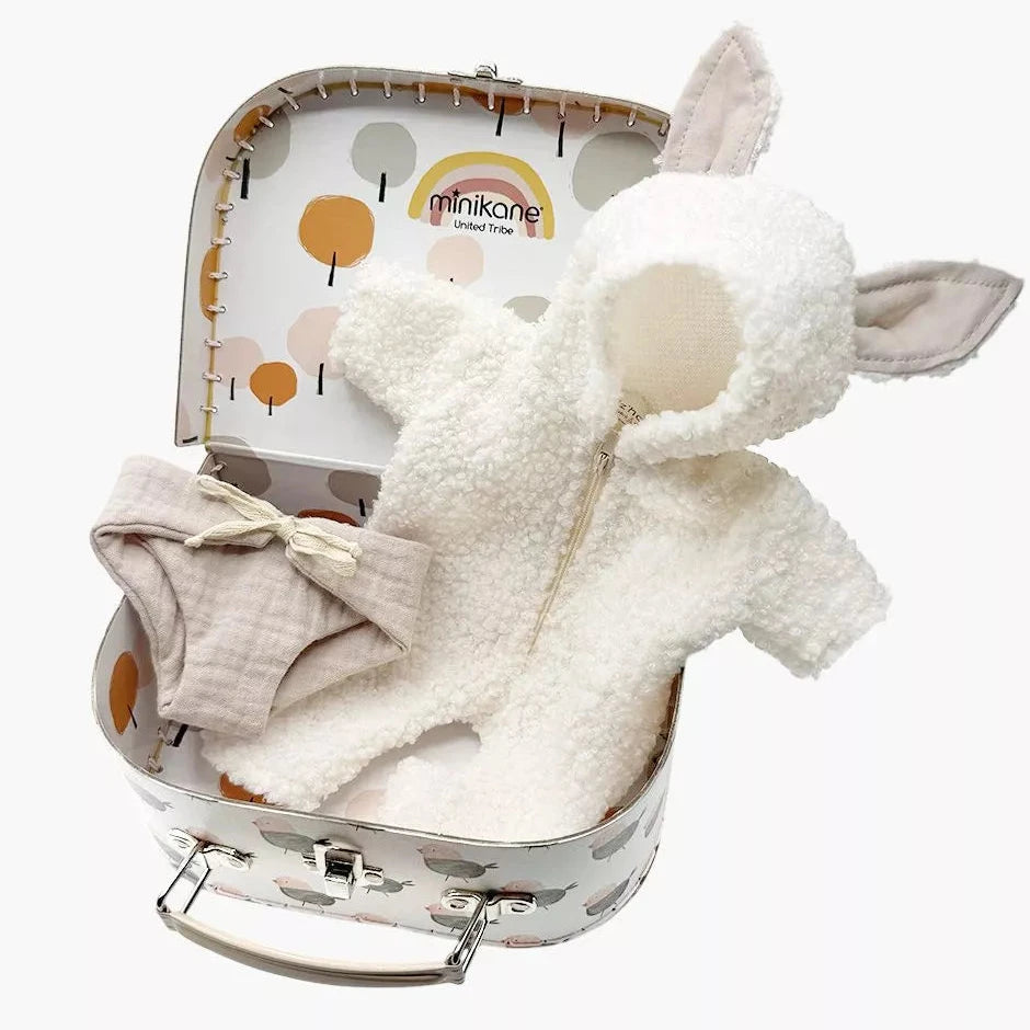 White plush doll suit with ears and cotton diaper in a small suitcase labeled 'minikane' on a white background