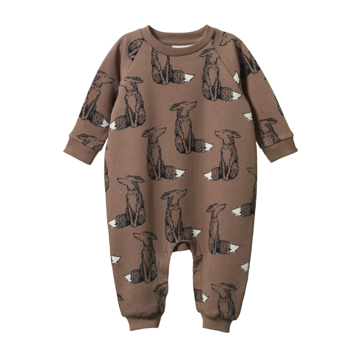 Baby in a brown onesie with Fox prints standing in a grassy area, holding hands with two adults.