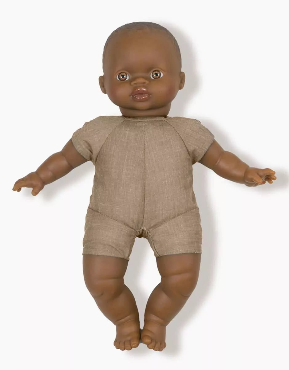Baby doll with brown skin and outfit on a white background