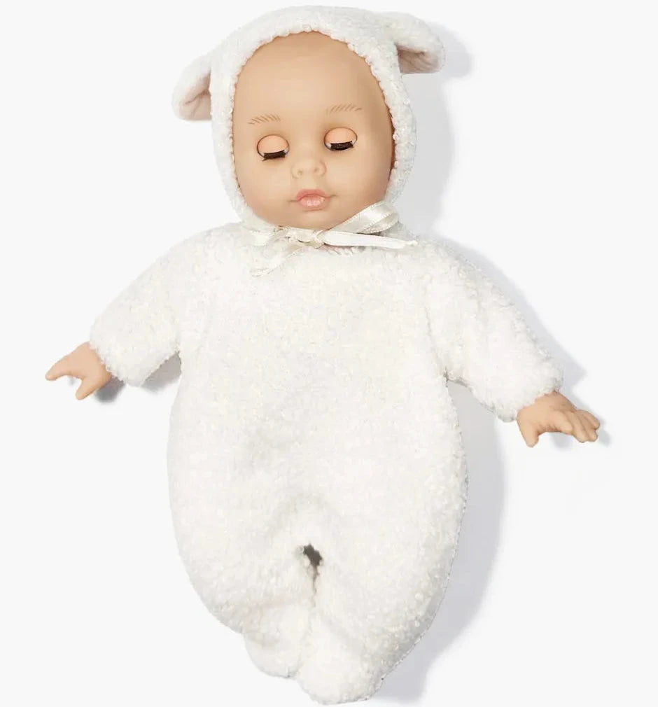 Baby doll in a white fluffy outfit with lamb ears on a white background