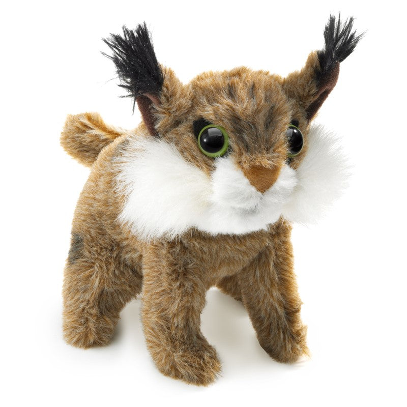 Plush toy resembling a bobcat animal with brown, black, and white fur on a white background