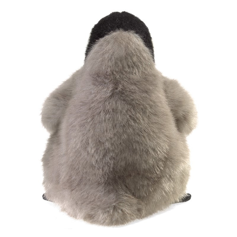 Plush penguin toy from behind on a white background