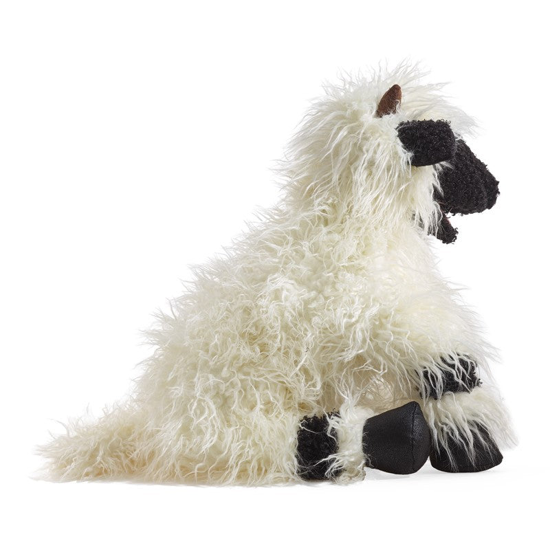 Plush toy resembling a white sheep  with black accents on a white background