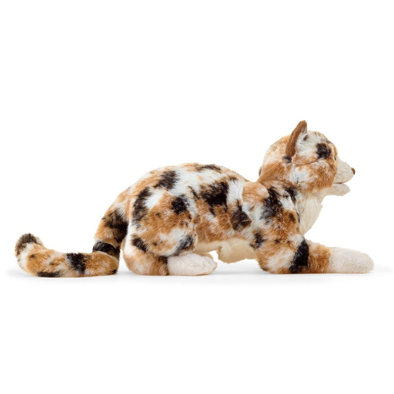 Plush toy cat with tortoiseshell pattern on a white background
