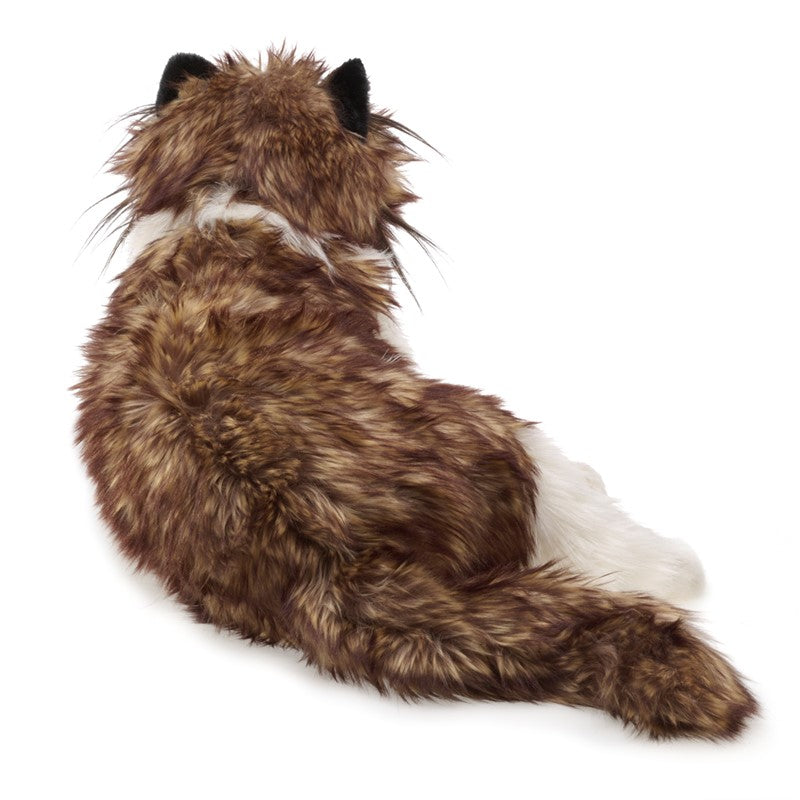 Plush toy resembling a cat with brown and white fur on a white background