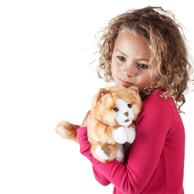 Plush toy cat with orange and white fur on a white background