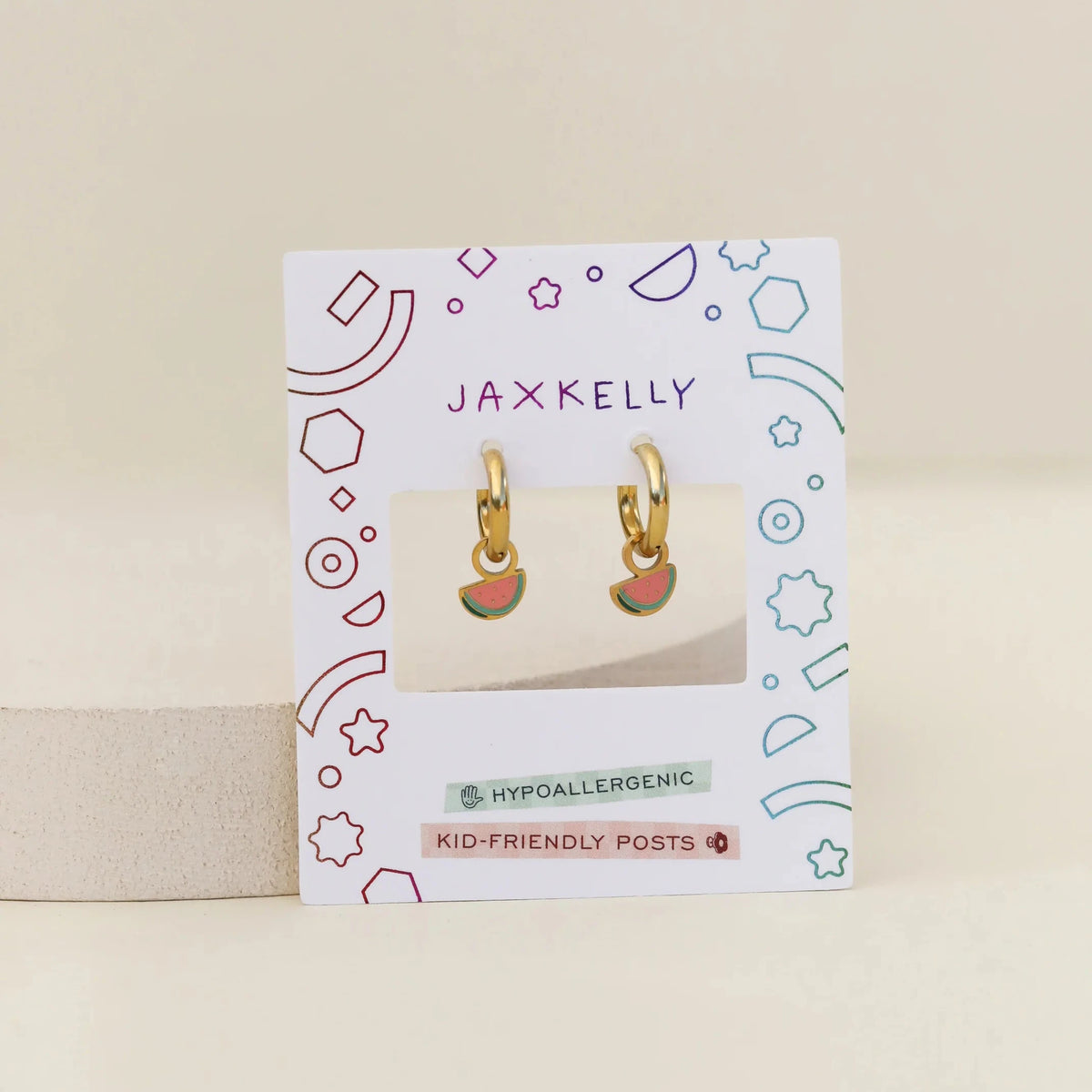 Jaxkelly earrings on a branded card with a beige background