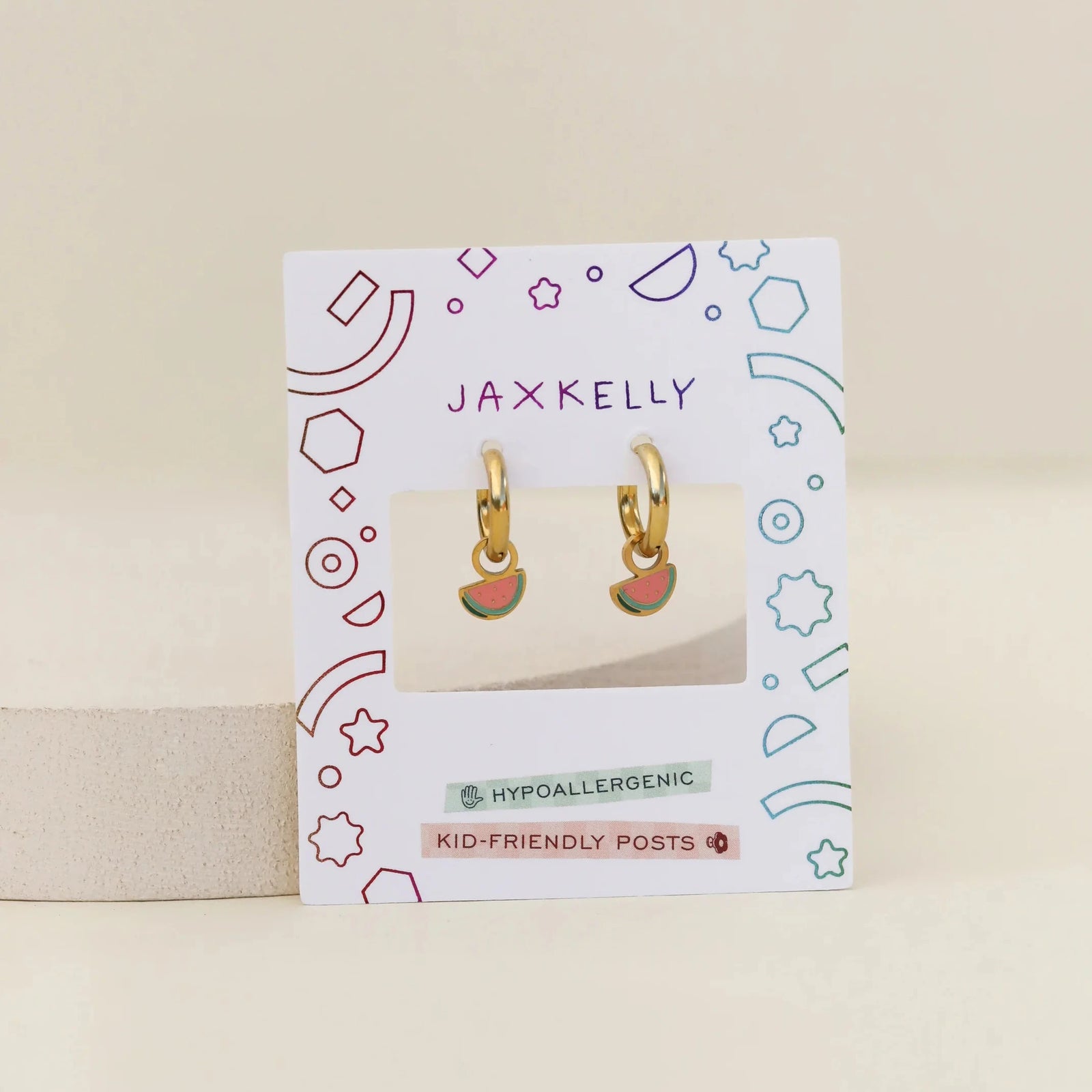 Gold hoop earrings with watermelon slice charms on a white background