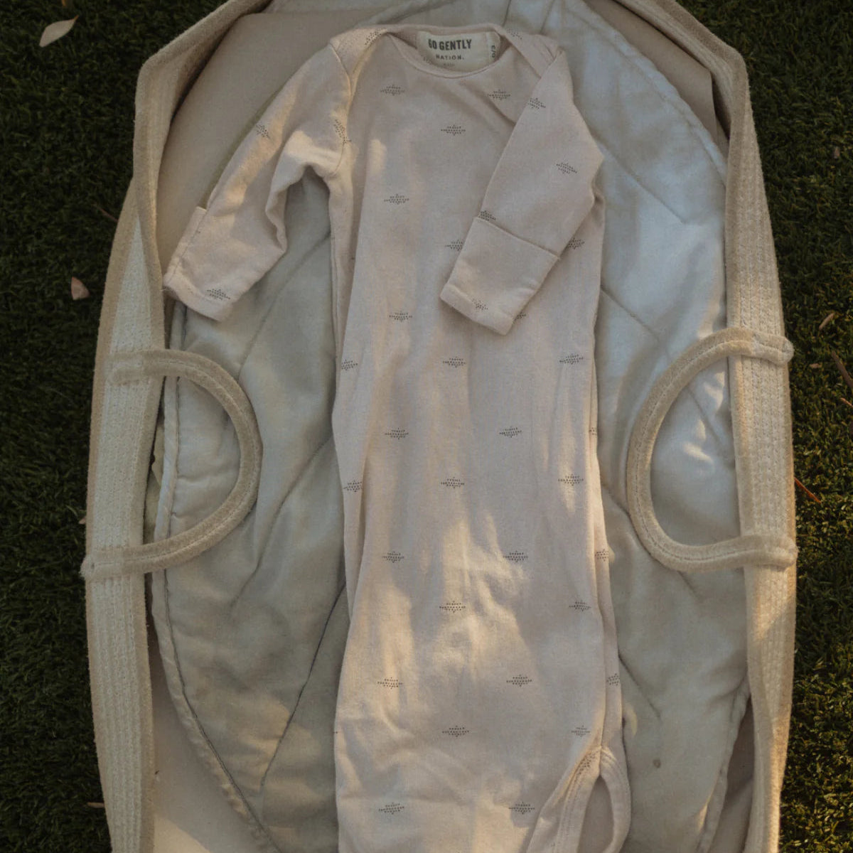 baby sleeping gown in a wicker basket