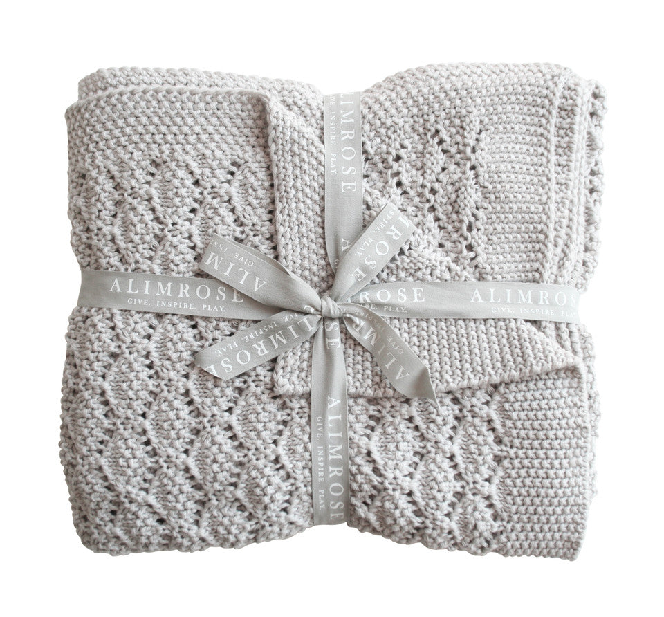 grey baby blanket wrapped in gift ribbon