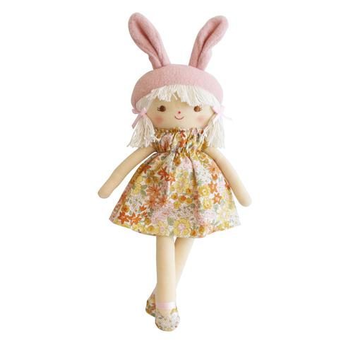 doll with lighter skin tone and blond ponytails in floral dress