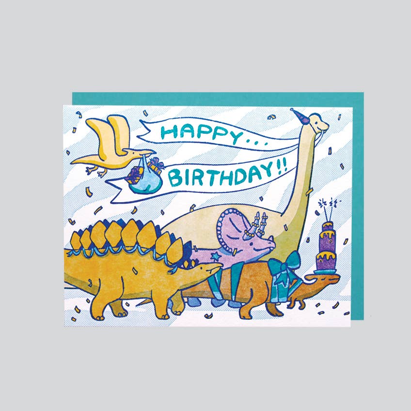 A colorful illustration of dinosaurs on a birthday card, with a 'Happy Birthday!' message and a deep-flap envelope.