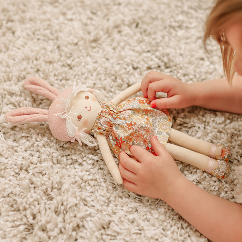 child playing with doll