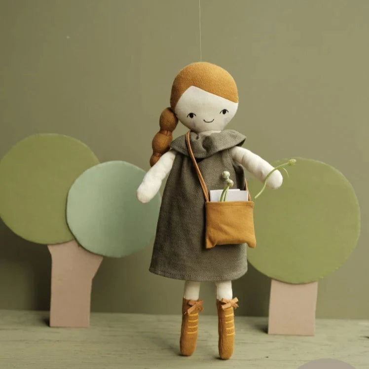 Three dolls with different outfits and hairstyles against a dark background